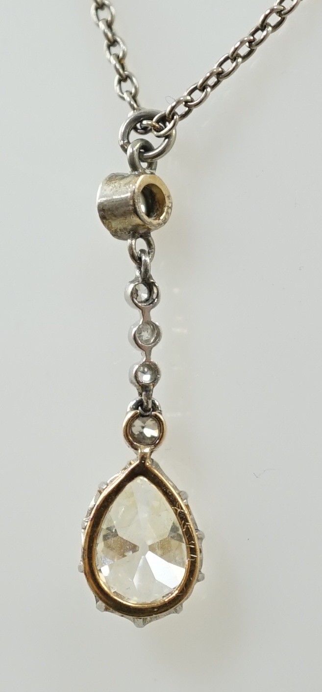 An early to mid 20th century white and yellow gold, six stone diamond set drop pendant, on a white gold chain, the clasp stamped 9k